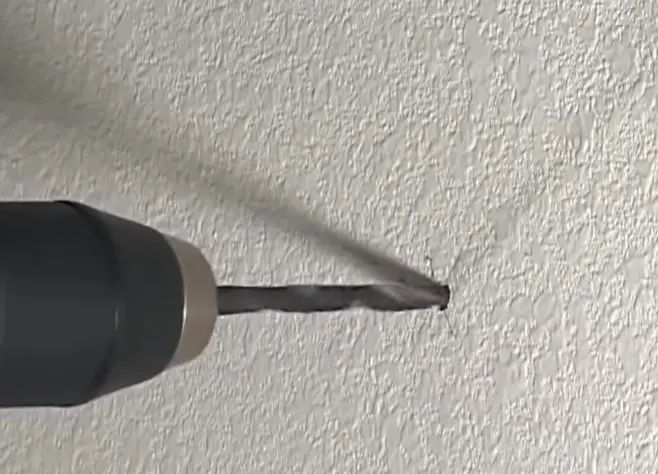 Drill Hole Into Drywall at Marked Spot With Appropriate Bit